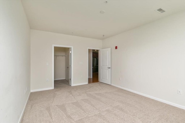 1 Francis Dr Unit 211, Andover, MA 01810 - unfurnished bedroom with light carpet, a spacious closet, baseboards, and a closet