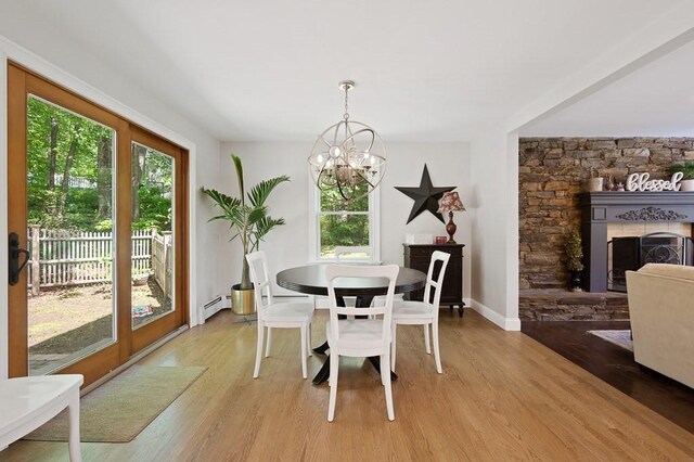 3 Squantum Rd, Paxton, MA 01612 - dining room with a baseboard heating unit, healthy amount of natural light, a chandelier, and light wood-type flooring