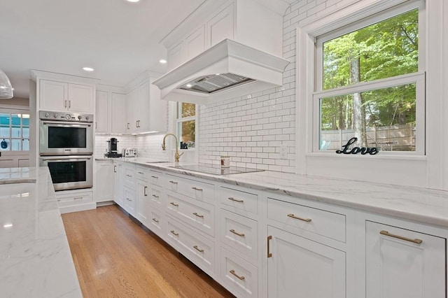 3 Squantum Rd, Paxton, MA 01612 - kitchen with double oven, black electric stovetop, plenty of natural light, white cabinets, and recessed lighting