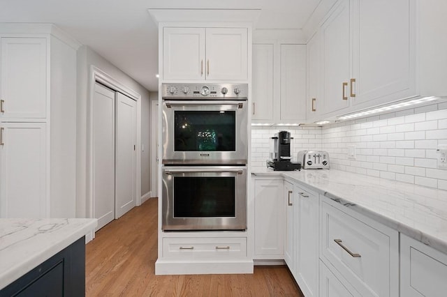 3 Squantum Rd, Paxton, MA 01612 - kitchen with double oven, white cabinets, light wood-style floors, and backsplash