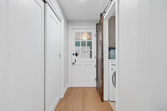 3 Squantum Rd, Paxton, MA 01612 - laundry room featuring washer / dryer, a barn door, and light wood-type flooring