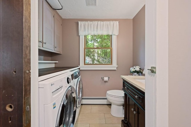 3 Squantum Rd, Paxton, MA 01612 - laundry room with washing machine and clothes dryer, a baseboard heating unit, baseboards, and light tile patterned flooring