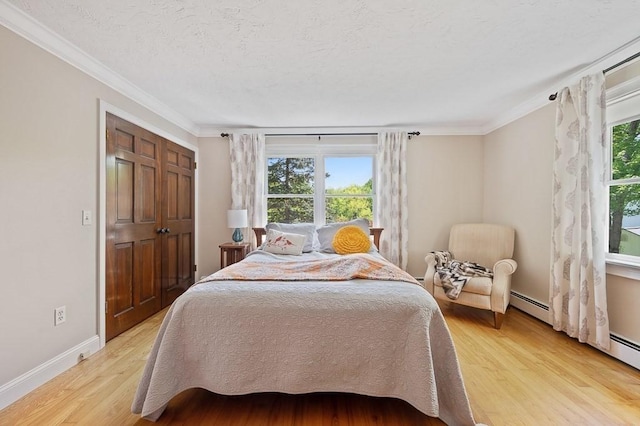 3 Squantum Rd, Paxton, MA 01612 - bedroom featuring crown molding, light wood-style floors, baseboards, baseboard heating, and a textured ceiling