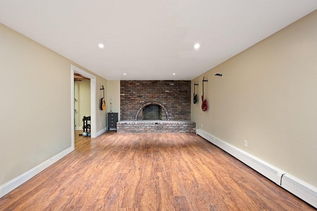 3 Squantum Rd, Paxton, MA 01612 - unfurnished living room featuring a baseboard heating unit, a fireplace, wood finished floors, baseboards, and recessed lighting