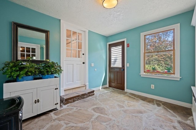 3 Squantum Rd, Paxton, MA 01612 - foyer entrance with stone floors, a textured ceiling, and baseboards
