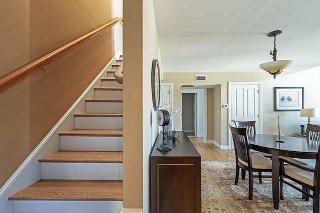 stairs featuring wood-type flooring