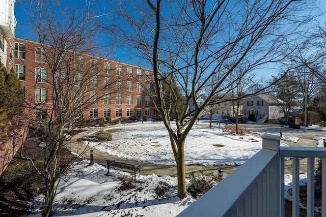 snowy yard with a balcony