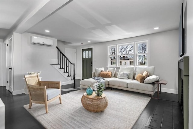 living area featuring stairway, recessed lighting, a wall mounted air conditioner, and baseboards