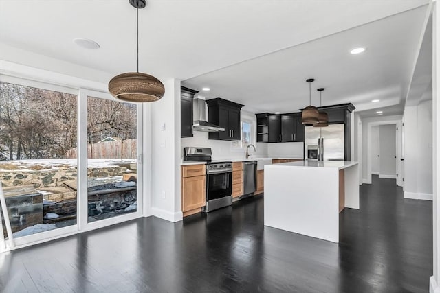 kitchen featuring dark wood-style floors, a sink, hanging light fixtures, light countertops, and stainless steel appliances