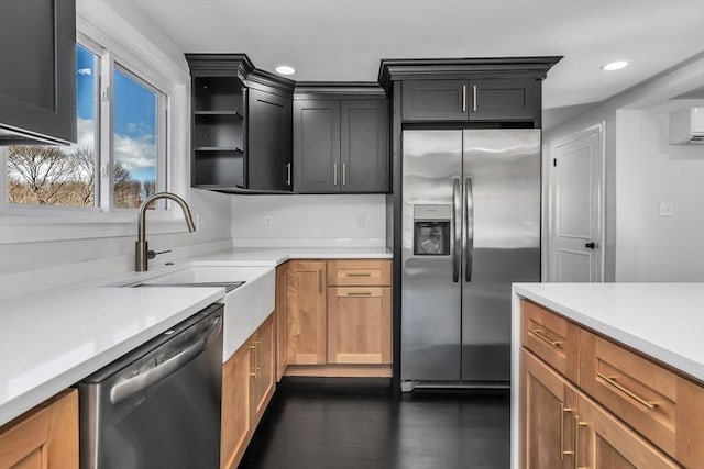 kitchen featuring dark wood-type flooring, a sink, recessed lighting, stainless steel appliances, and light countertops