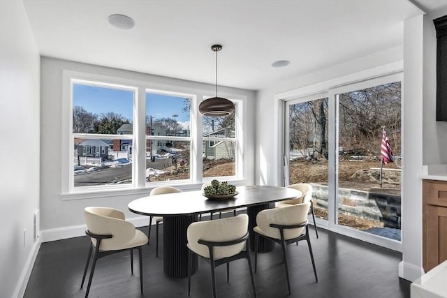 dining area featuring dark wood finished floors and baseboards