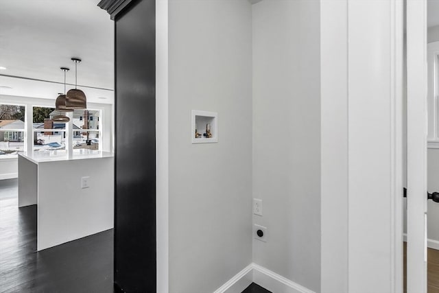 laundry area with electric dryer hookup, baseboards, dark wood-type flooring, and hookup for a washing machine