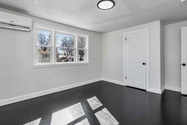 empty room with baseboards and an AC wall unit