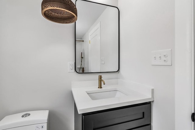 bathroom with toilet and vanity