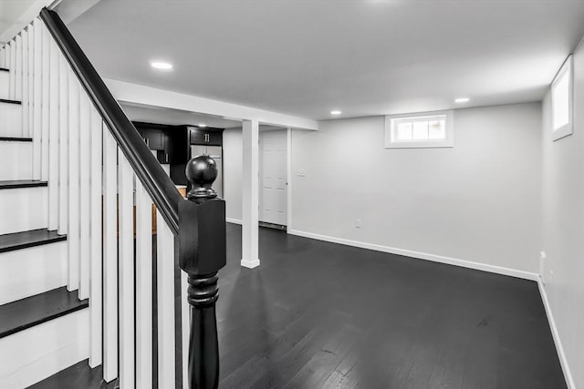 basement featuring stairway, recessed lighting, baseboards, and dark wood-style flooring