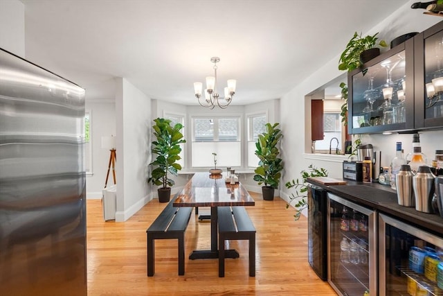 8 Brinton St Unit 2, Boston, MA 02119 - dining area featuring wine cooler, light wood finished floors, a bar, and a chandelier