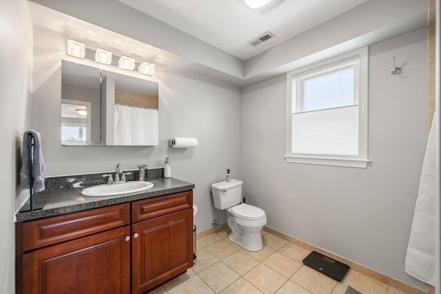 8 Brinton St Unit 2, Boston, MA 02119 - full bath featuring vanity, toilet, tile patterned floors, and baseboards