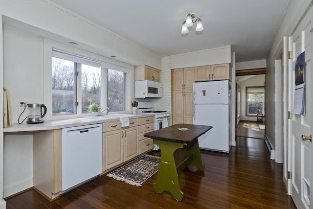 kitchen featuring a sink, light brown cabinetry, plenty of natural light, white appliances, and dark wood-style flooring