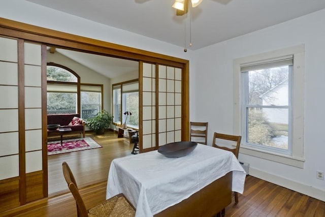 dining area featuring ceiling fan, baseboards, lofted ceiling, and wood finished floors