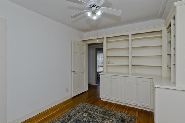 bedroom with dark wood finished floors, a ceiling fan, and baseboards