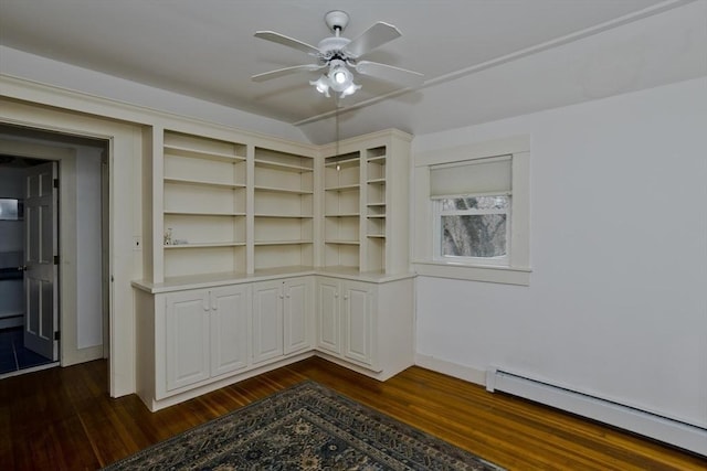 empty room with a baseboard radiator, dark wood finished floors, a ceiling fan, and vaulted ceiling