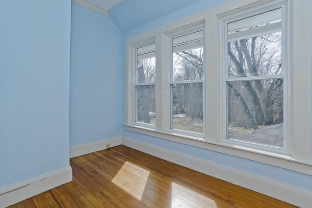 unfurnished room featuring baseboards and dark wood-style floors