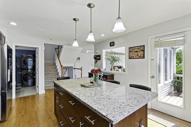 15 Queen Isabella Way Unit 15, Ashland, MA 01721 - kitchen with estacked washer and dryer, smart refrigerator, a kitchen island, hanging light fixtures, and recessed lighting