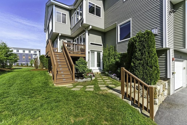 15 Queen Isabella Way Unit 15, Ashland, MA 01721 - back of house with stairway, a yard, a deck, an attached garage, and driveway