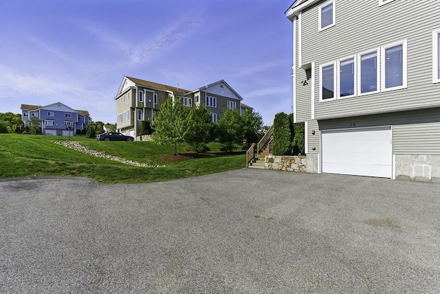 15 Queen Isabella Way Unit 15, Ashland, MA 01721 - view of property exterior featuring a garage, a residential view, driveway, stairs, and a yard