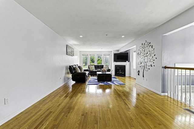 15 Queen Isabella Way Unit 15, Ashland, MA 01721 - living area with wood finished floors, a glass covered fireplace, baseboards, and recessed lighting