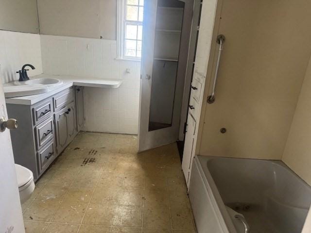 150 Saint Bernard St, Fitchburg, MA 01420 - full bath featuring tile walls, toilet, a wainscoted wall, and vanity