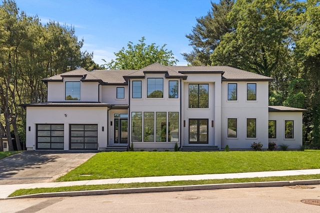 view of front facade with a garage and a front lawn