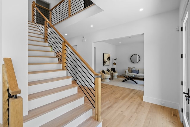 stairway featuring wood-type flooring