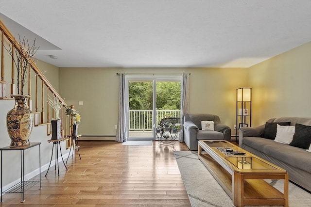 127 Bayberry Hill Ln Unit 127, Leominster, MA 01453 - living area featuring stairway, light wood-type flooring, and a baseboard radiator