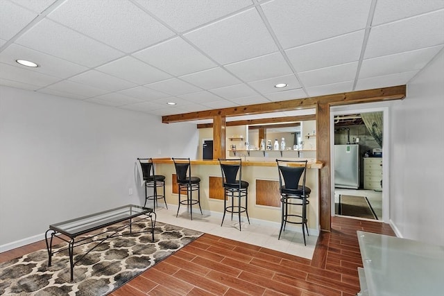 127 Bayberry Hill Ln Unit 127, Leominster, MA 01453 - bar featuring recessed lighting, wood finished floors, freestanding refrigerator, baseboards, and a drop ceiling