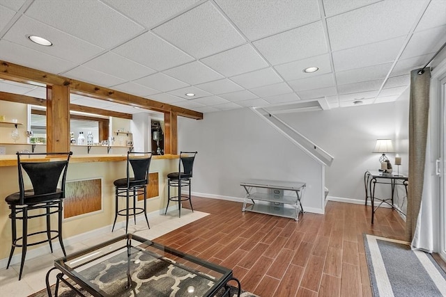 127 Bayberry Hill Ln Unit 127, Leominster, MA 01453 - living room featuring a drop ceiling, recessed lighting, wood finished floors, baseboards, and bar