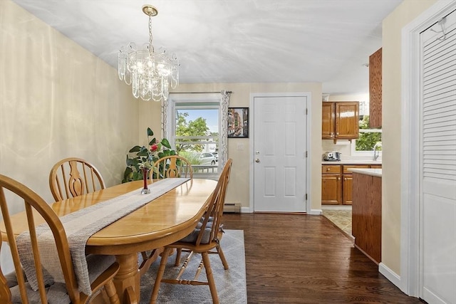 127 Bayberry Hill Ln Unit 127, Leominster, MA 01453 - dining space featuring a chandelier, dark wood-style floors, baseboards, and a baseboard radiator
