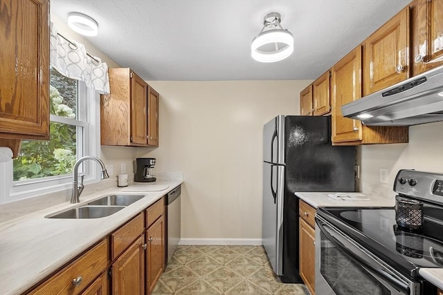127 Bayberry Hill Ln Unit 127, Leominster, MA 01453 - kitchen with appliances with stainless steel finishes, under cabinet range hood, a sink, brown cabinets, and light countertops