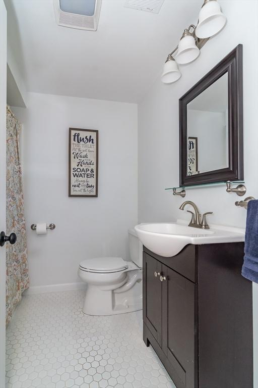 120 Hartford St, Natick, MA 01760 - bathroom with vanity, toilet, baseboards, and tile patterned floors
