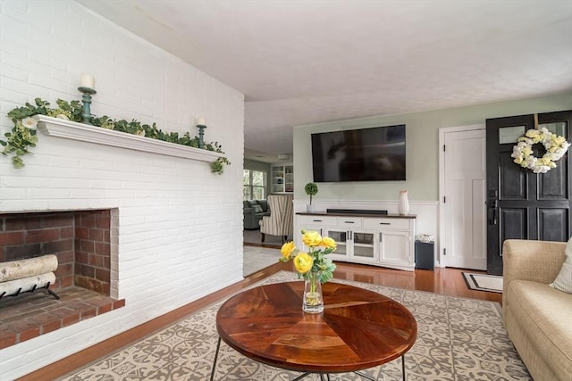 120 Hartford St, Natick, MA 01760 - living room with wood finished floors, a fireplace, and a wainscoted wall