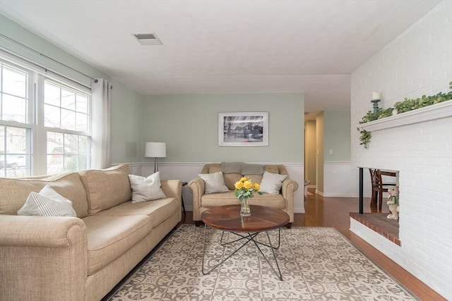 120 Hartford St, Natick, MA 01760 - living area featuring wood finished floors and a brick fireplace