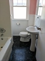 bathroom featuring shower / tub combination and toilet