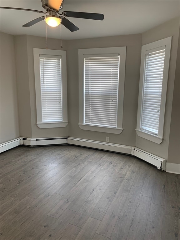 spare room featuring ceiling fan, plenty of natural light, and light hardwood / wood-style flooring