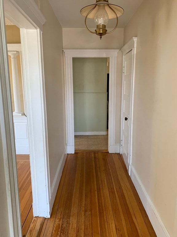 corridor with wood-type flooring