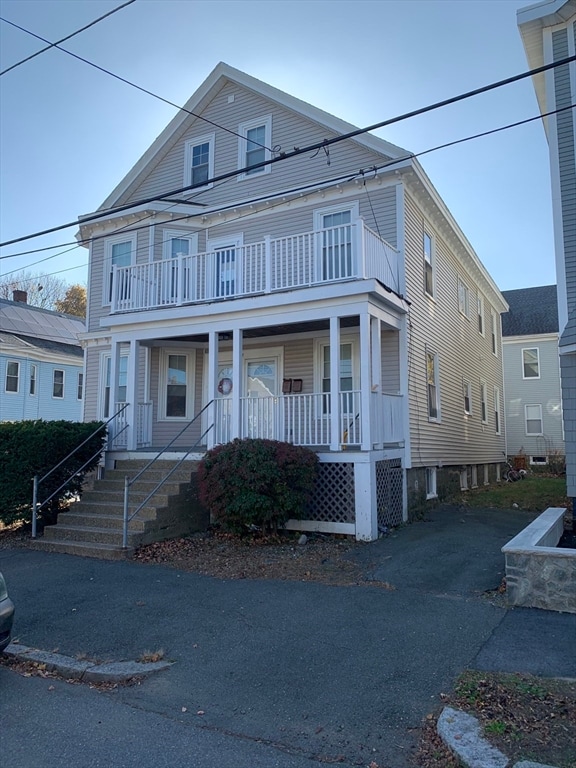 view of front of property with covered porch and a balcony