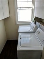 laundry area with cabinets and washer and clothes dryer