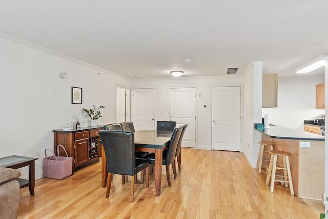 1818 Main St Unit 307, Holden, MA 01522 - dining room featuring light wood-style flooring, ornamental molding, and baseboards