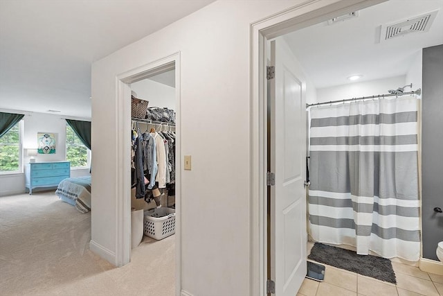 1818 Main St Unit 307, Holden, MA 01522 - bathroom featuring ensuite bathroom, a shower with shower curtain, baseboards, a spacious closet, and tile patterned flooring