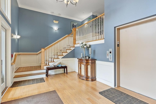1818 Main St Unit 307, Holden, MA 01522 - foyer with stairs, wood finished floors, wainscoting, ornamental molding, and a chandelier