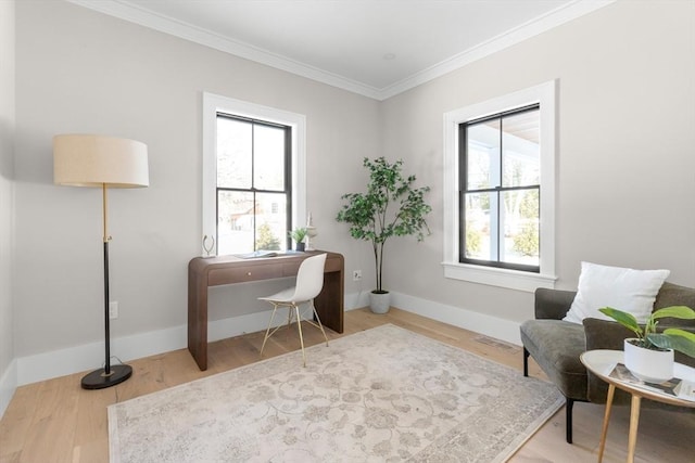 home office with a wealth of natural light, ornamental molding, and hardwood / wood-style flooring